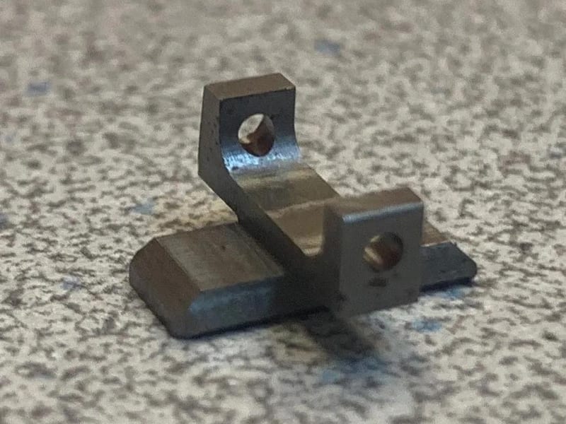 Aro-Tek tritium gun sight on concrete — precision machined in Tumwater, WA
